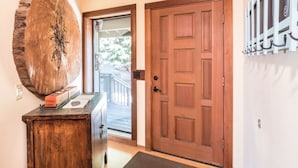 A wooden door with a glass panel, a wooden bench with a rustic design, and a large wooden sculpture on the wall. - September and October dates are available!!! Are Panoramic Ocean Views for you ? (Manchester)