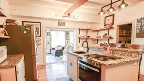 A kitchen with a granite countertop, stainless steel appliances, and wooden cabinets.