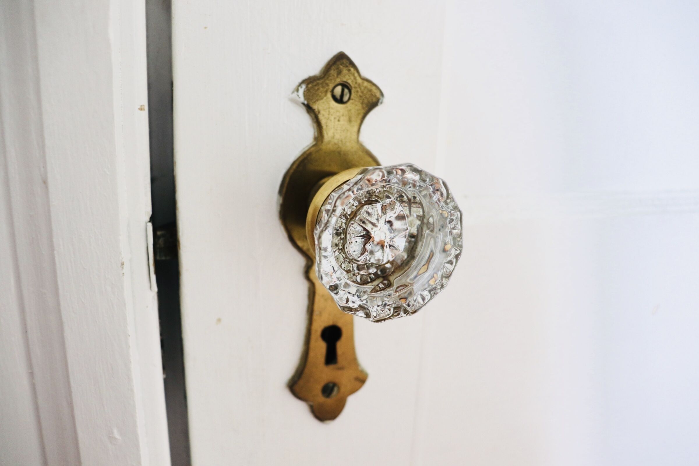 A brass door knocker with a star-shaped top and a keyhole below it.