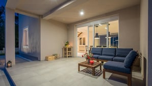 A modern outdoor living area with a sofa, coffee table, and potted plants. - Pet friendly home in Vrh (Vrh)