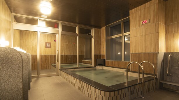 A modern indoor pool area with a glass enclosure, wooden paneling, and a digital clock displaying 4:06.