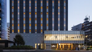 A modern hotel building with a sign reading "Wires Hotel."