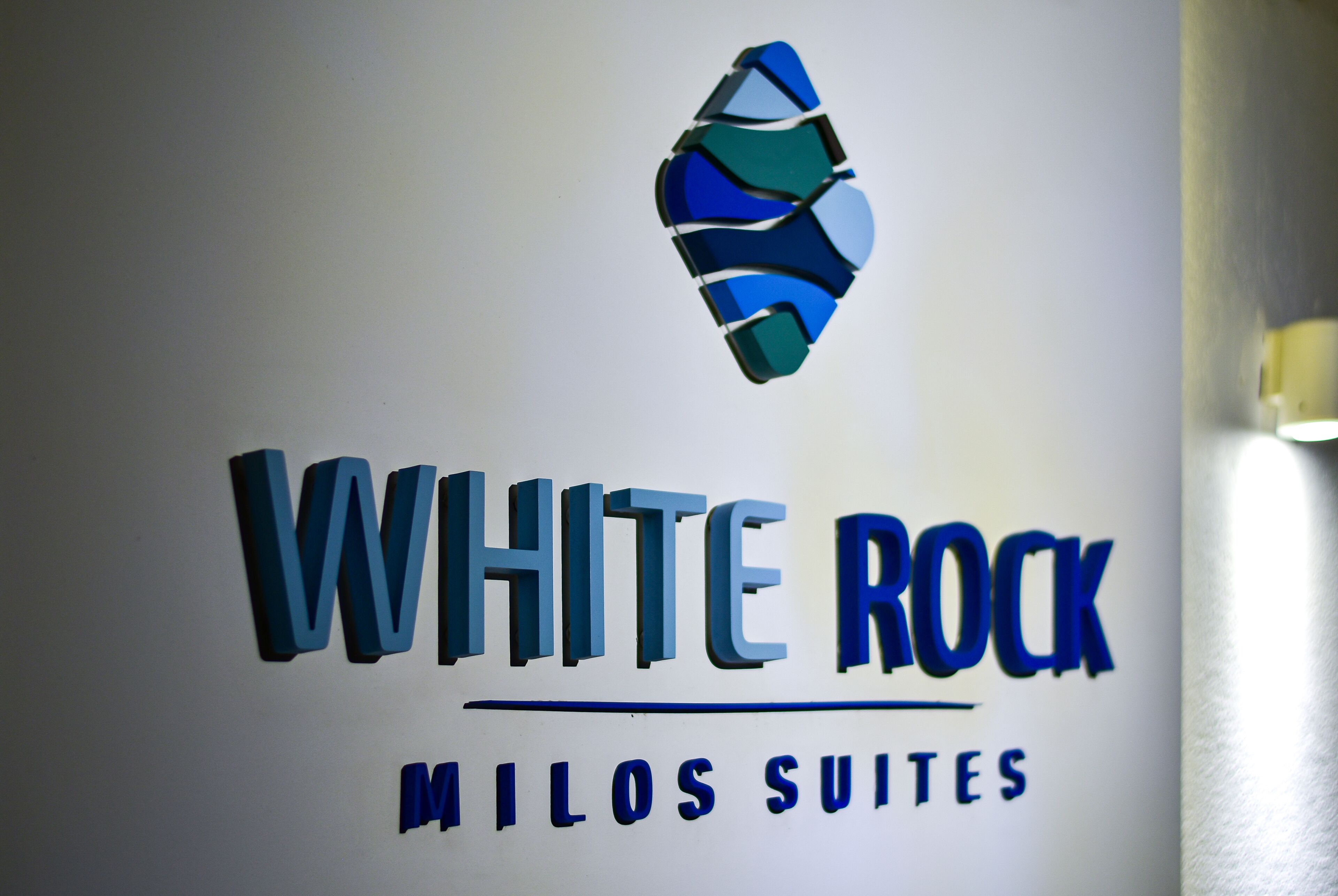 A logo with the text "WHITE ROCK MILOS SUITES".