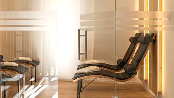 Relax in a serene spa room with a wall-mounted massage chair and a view.