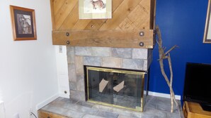 A fireplace with a stone surround and a wooden mantel. - Remodeled Gem On the Free Shuttle Route Walkable to Restaurants and Shops (Keystone)