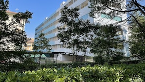 A multi-story building with balconies, surrounded by trees and greenery. - Condominio Isola Clara (San Michele al Tagliamento)