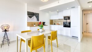 A modern kitchen with white cabinets, a built-in oven, and a coffee machine. - Cosy apartment for 5 guests with WIFI, A/C, pool, TV and terrace (Roses)
