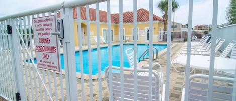 A pool area with a sign indicating it is for the exclusive use of Ciboney Condominiums.