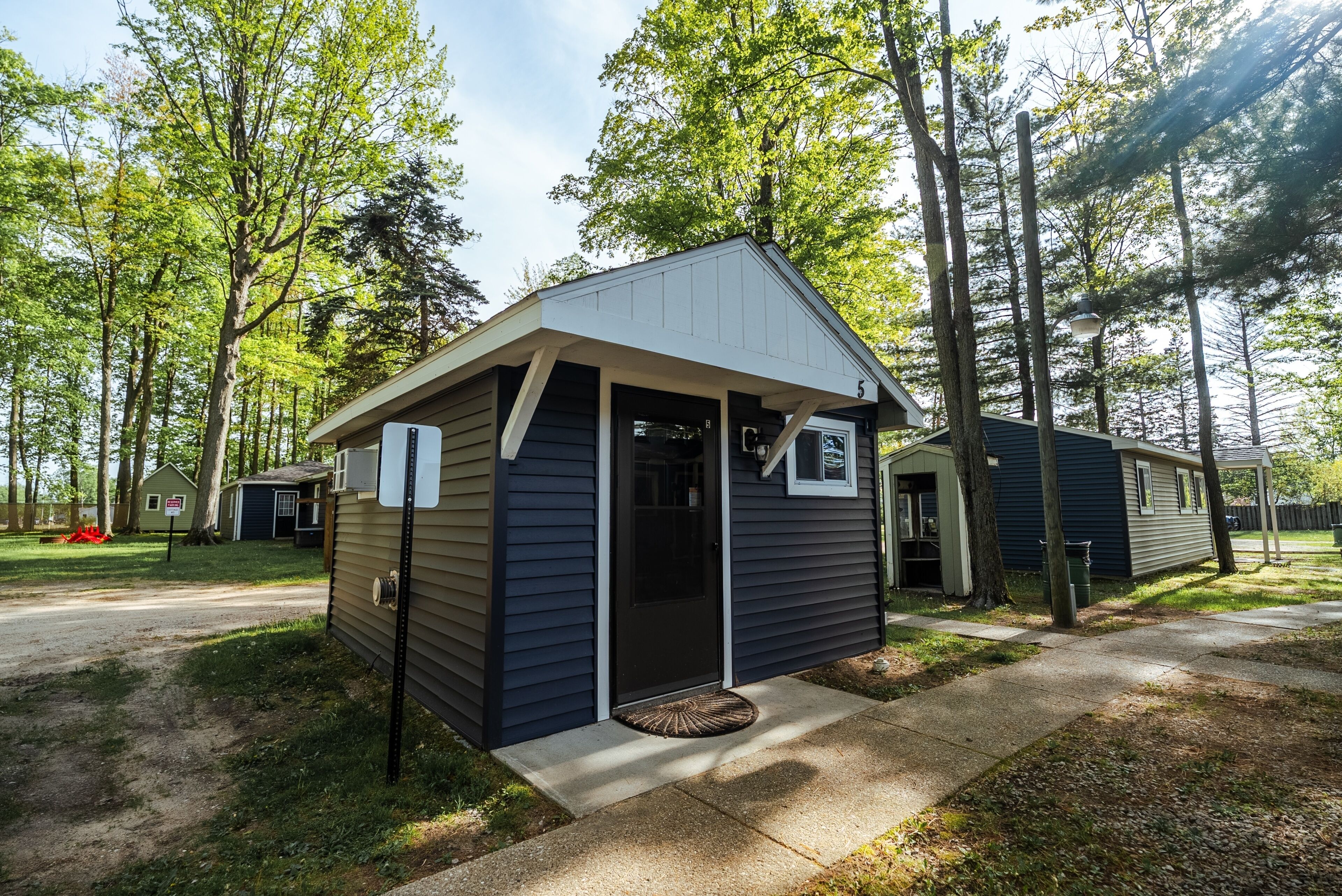 A small, single-story cabin with a gabled roof and a front porch.