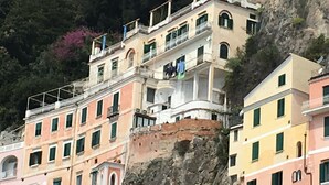 A multi-story building with balconies, situated on a cliff with a forested background. - Apartments Amalfi Design Sea View (Amalfi)