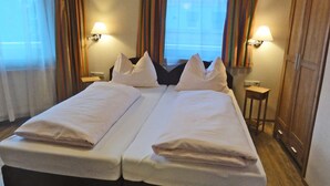 A double bed with white linens, two bedside tables with lamps, and a wooden wardrobe. - Apartment in Stumm Near Zillertal Ski Area (Stumm)