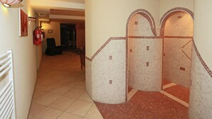 A hallway with a tiled floor, a fire extinguisher, and a chair. - Apartment in Stumm Near Zillertal Ski Area (Stumm)