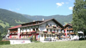 A traditional mountain hotel with multiple balconies, a red roof, and a sign indicating it is a guesthouse. - Apartment in Stumm Near Zillertal Ski Area (Stumm)