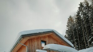A wooden chalet with a sloped roof, a balcony, and a ski rack. - Chalet in Dachstein West With Shared Pool (Annaberg-Lungoetz)