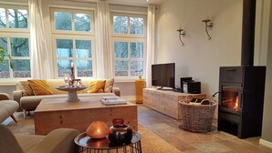 A cozy living room with a fireplace, a television, and a comfortable seating area.