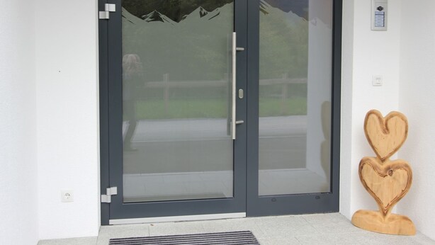 A modern sliding glass door with a view of a mountain landscape. - Luxurious Apartment in Fugenberg With Balcony (Fuegenberg)