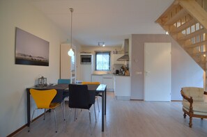 A modern kitchen with white cabinets, a built-in oven, and a window. - Holiday Home in Heeten Near Forest (Heeten)