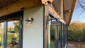 A modern building with large glass windows, a wooden ceiling, and a sign that reads "Villa d'argento". - Tranquil Holiday Home in Alphen-chaam With Stables (Alphen)