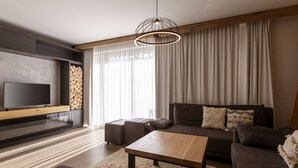 A modern living room with a flat-screen TV, a wooden coffee table, a sofa, and a large window with curtains. - Apartment With Sauna (Schladming)