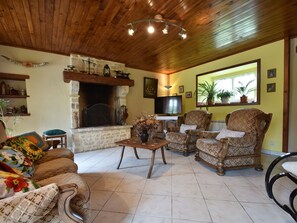 House | Living room | Fireplace, DVD player - Cozy Holiday Home in Gourbesville France With Fireplace (Picauville)