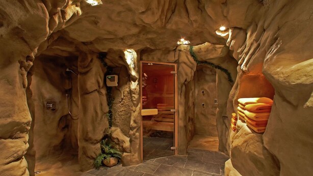 A cave-like interior with a wooden door, stone walls, and a tiled floor. - Posh Mansion in Sankt with 2 Saunas, Whirlpool, Hot Tub (Sankt Anton am Arlberg)