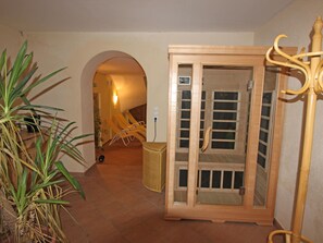 Traditional design with a wicker basket and arched doorway leading to a seating area with chairs and a table.