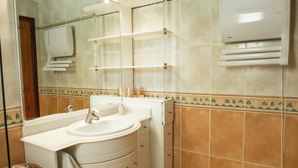 A bathroom with a sink, mirror, towel rack, and a trash bin. - Chic Narbonne Pool Retreat (Narbonne)