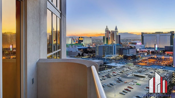 A cityscape view from a high-rise building with a parking lot below. - MGM Signature-F1 Track View Near Strip Lazy River (Las Vegas)