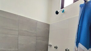 A bathroom with grey and white tiled walls, a shower curtain, and a window. - Hotel Costa Maria (Ciudad del Carmen)