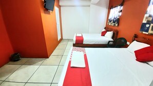 A hotel room with two beds, a TV mounted on the wall, and a mirror with pictures. - Hotel Costa Maria (Ciudad del Carmen)