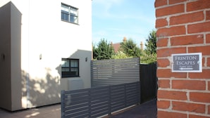 A gated entrance to a building with a sign indicating 'FRITON ESCAPES' and a direction to turn left. - Frinton Escapes (Frinton-on-Sea)