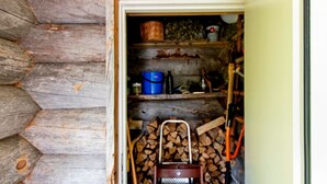 A rustic wooden cabin interior with a wooden ladder, a blue bucket, and a shelf with various items. - Hankipolku 7b / ukuli by Interhome (Ylläsjärvi)