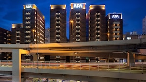 A multi-story building with 'APA' signage on the top of each building, indicating it is a hotel. - APA HOTEL Roppongi Six (Tokyo)