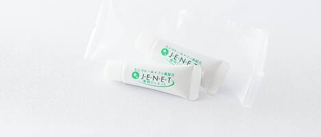 Two white sachets with green and black text on a white textured background.