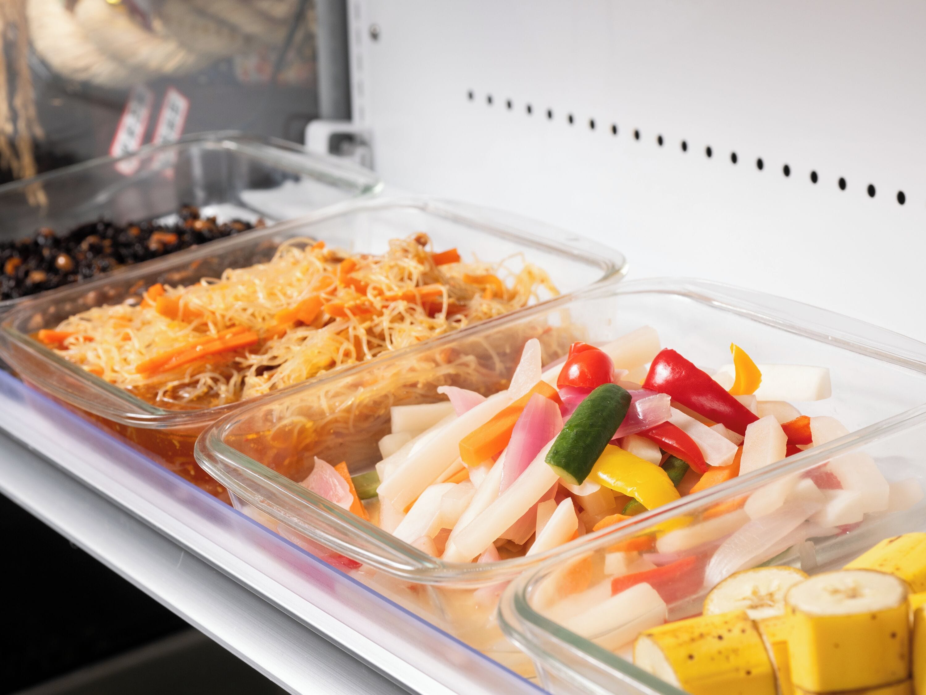 A buffet with various food items including sliced vegetables and cheese.