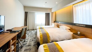 A hotel room with two beds, a desk, a chair, a TV, and a window with curtains. - HOTEL Kazusaya (Tokyo)