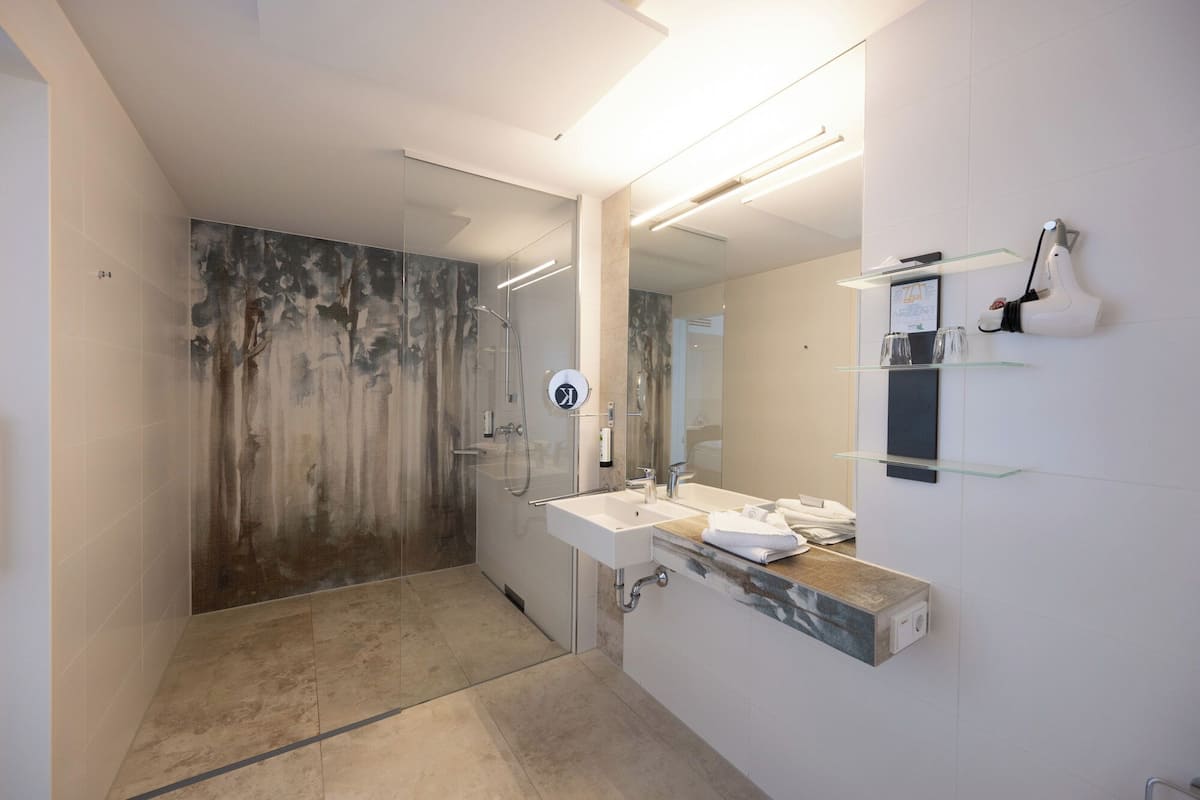 superior double room | bathroom | shower, free toiletries, hair dryer, towels