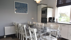 Private kitchen | Fridge, high chair - Spacious Farmhouse in Ijzendijke With Garden (IJzendijke)