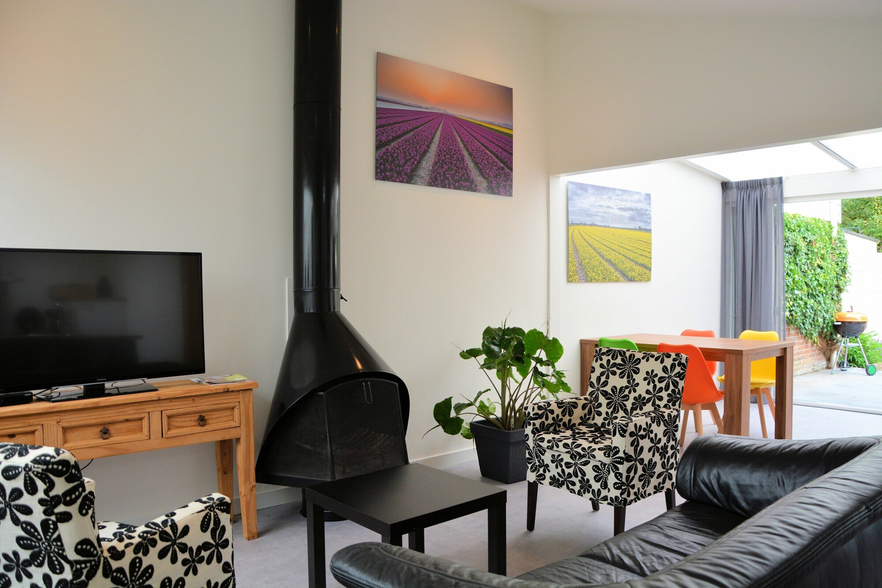 A living room with a TV, fireplace, and seating area.