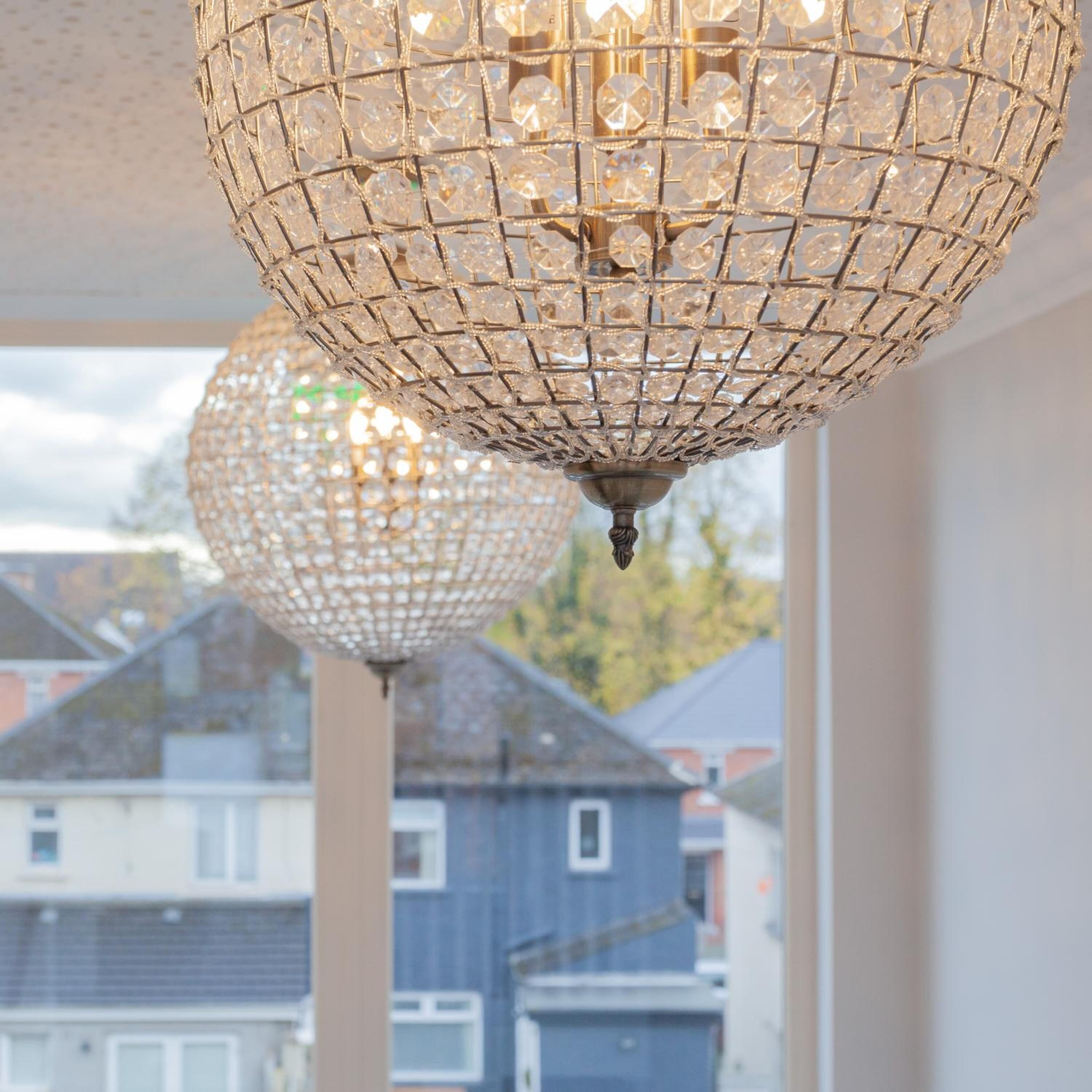 A chandelier with a geometric design, hanging from a ceiling.