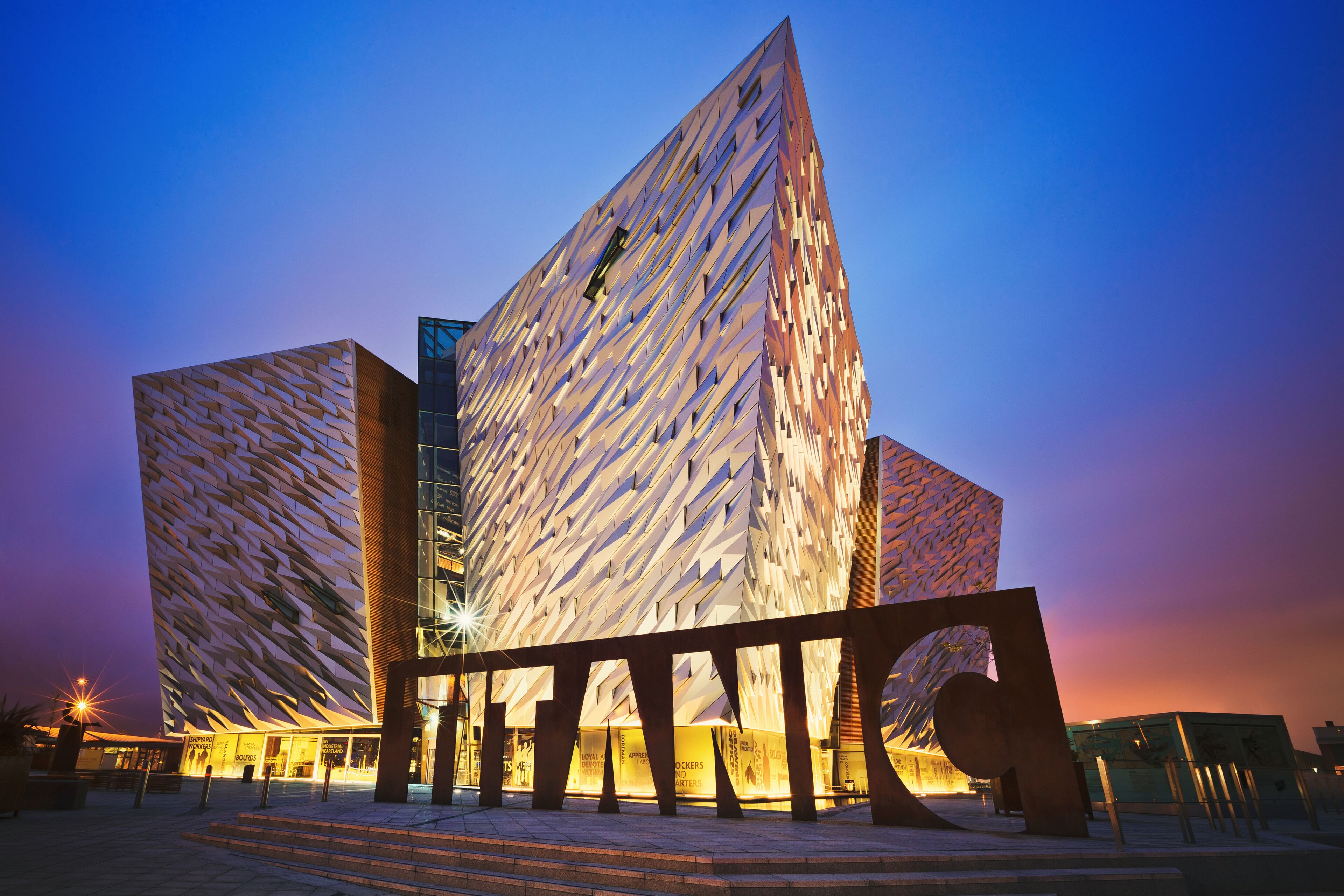 A modern building with a unique geometric facade and a prominent entrance area.