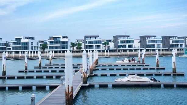 A marina with multiple docks, a wooden pier, and modern buildings with large windows. - Putian Hotel (Xiamen Mingfa Plaza) (Xiamen)