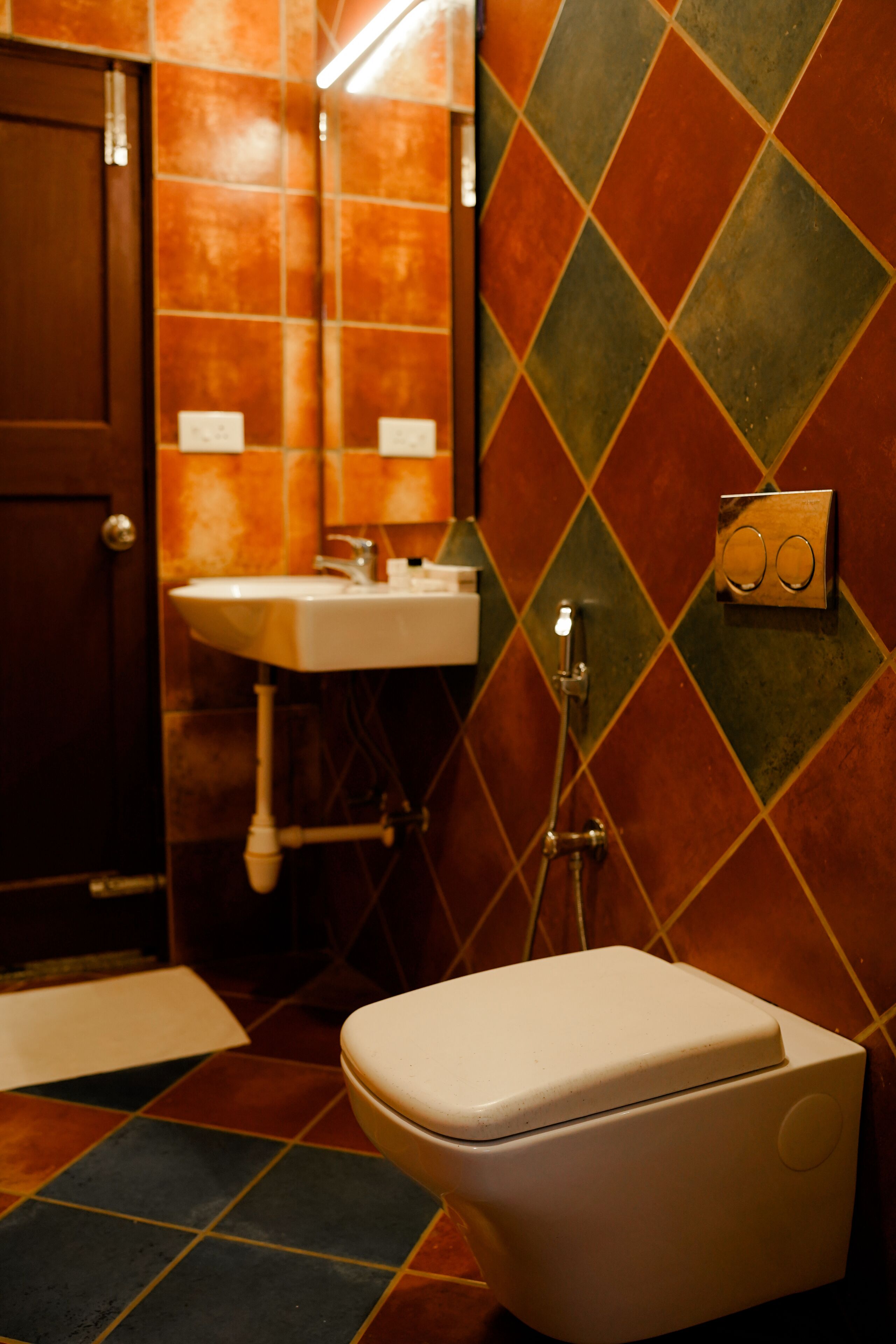 A bathroom with a toilet, sink, and shower.