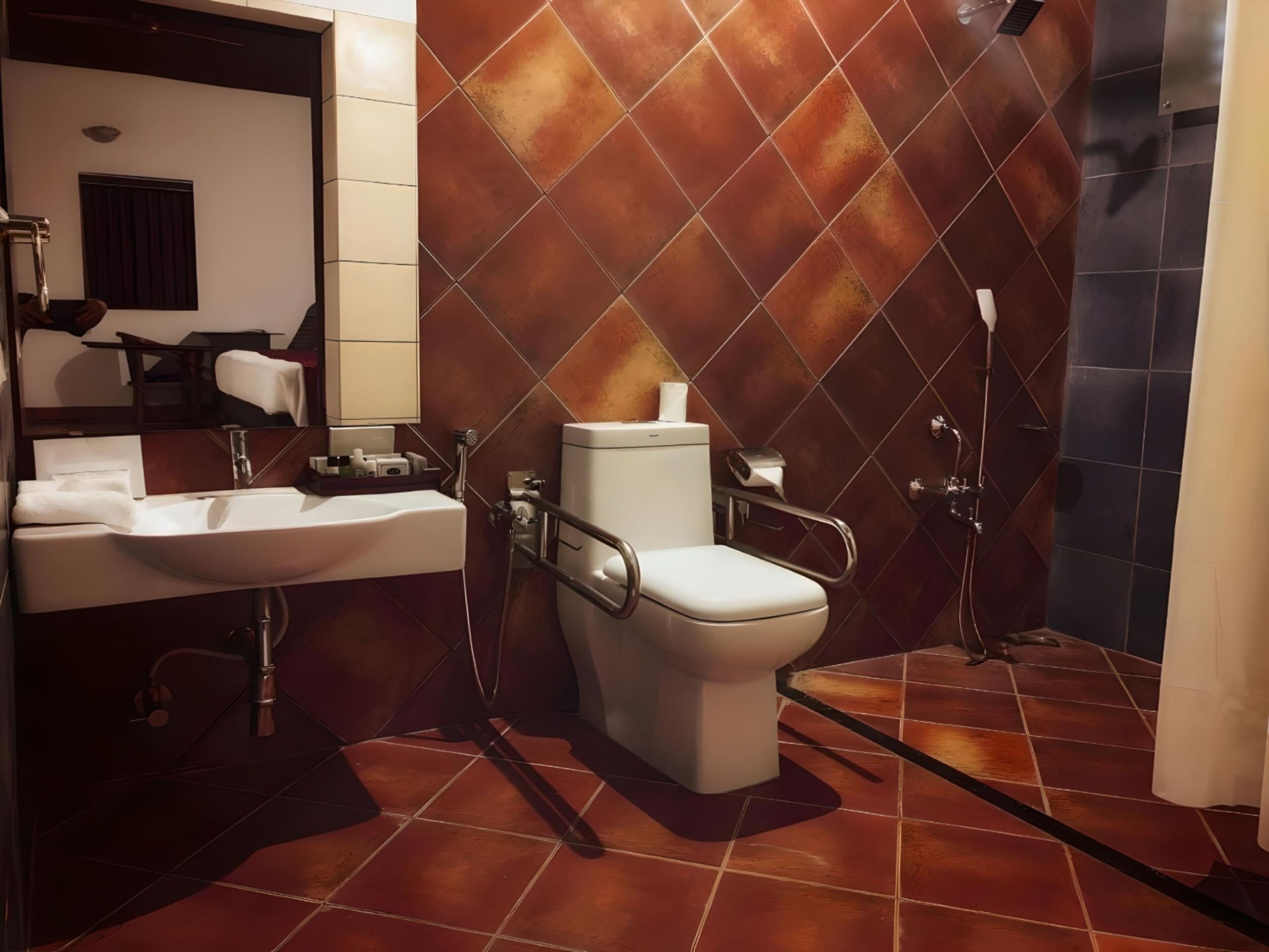 Un baño moderno con inodoro blanco, lavabo y zona de ducha.