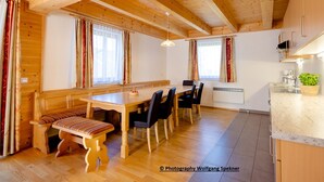 A wooden interior with a dining table, chairs, and a bench. - Chalet in Carinthia With Sauna Near Ski Slopes (Frantschach-Sankt Gertraud)