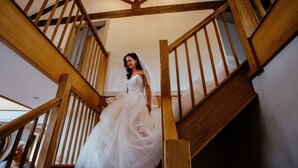 A bride descending a wooden staircase with a white wedding dress. - Luxury Stunning 5 Bed Barn Conversion Near Chester (Chester)