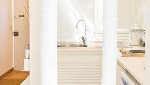 A modern bathroom with a sink, mirror, and white fixtures.