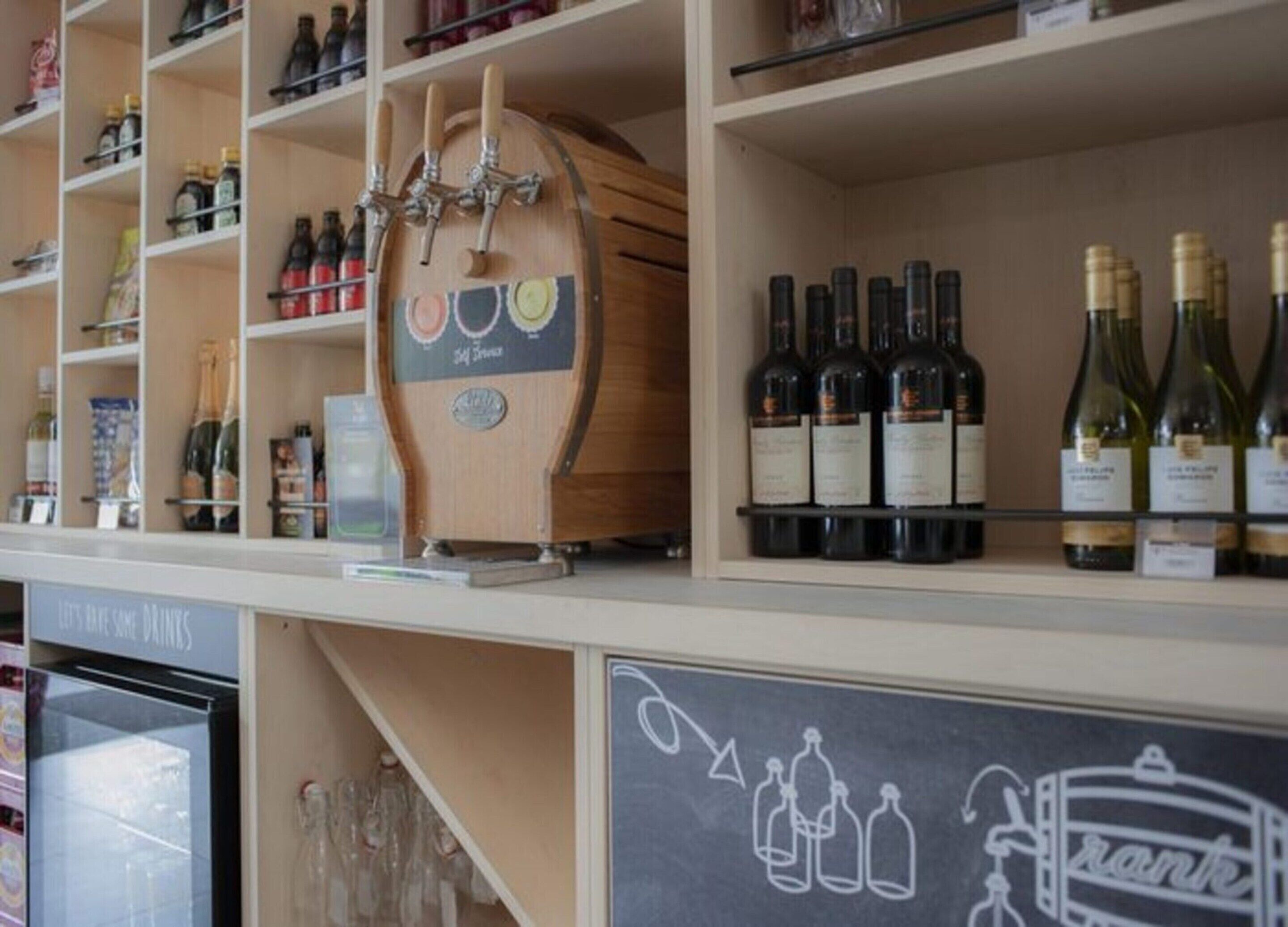 A wine rack with multiple bottles and a chalkboard sign with a drawing of bottles and a film strip.