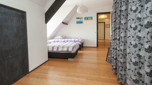 A bedroom with a bed, a ceiling light, and a door. - Luxurious Mansion in Callantsoog With Sauna (Callantsoog)