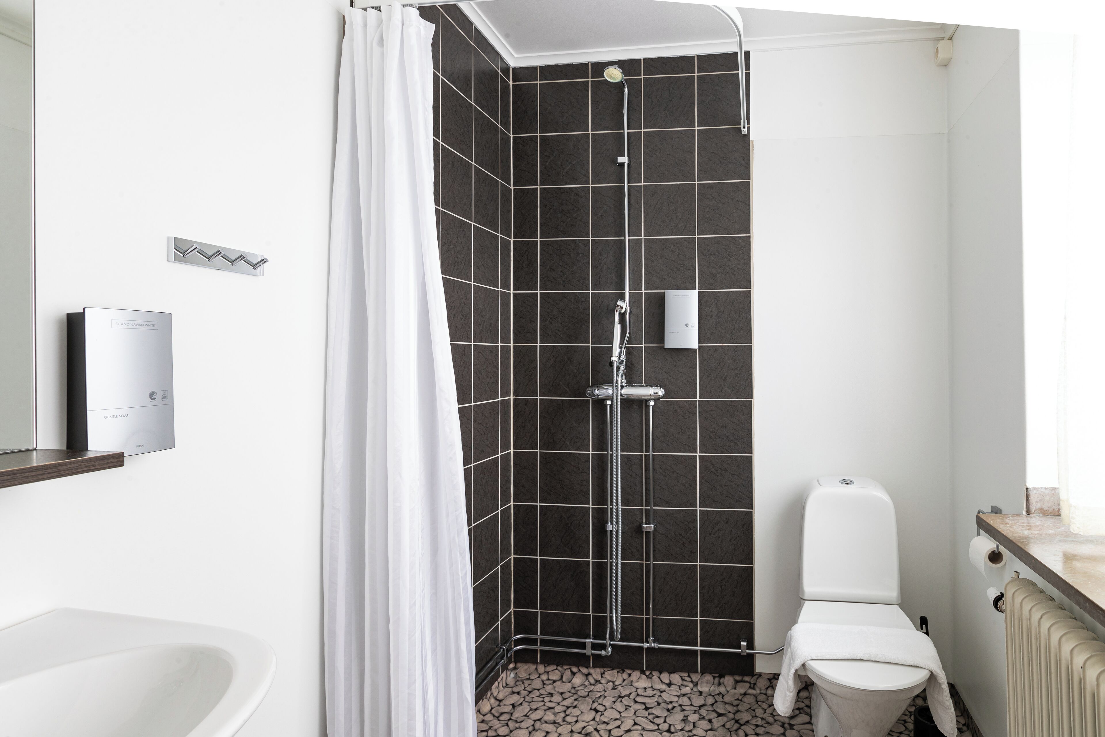 A modern bathroom with a shower, toilet, and bathtub.